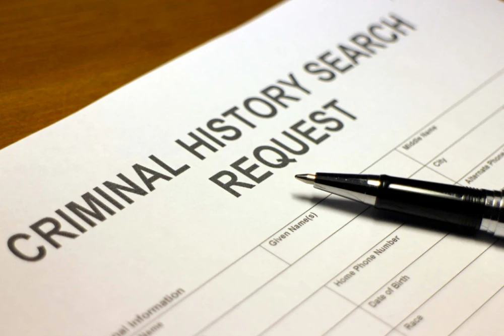 Criminal history search request form with a pen