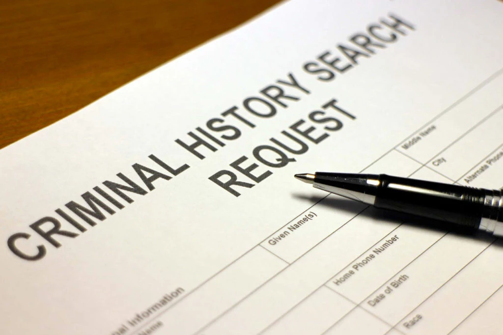 Criminal history search request form with a pen