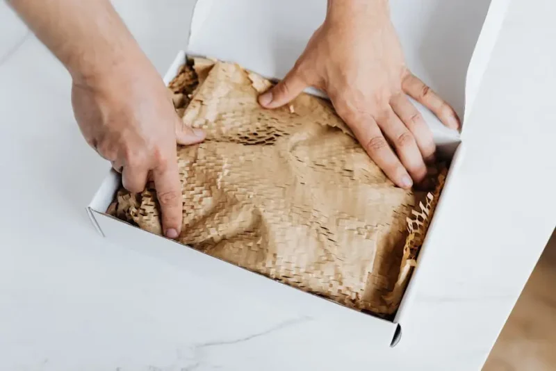 Hands installing insulation inside a home project opening