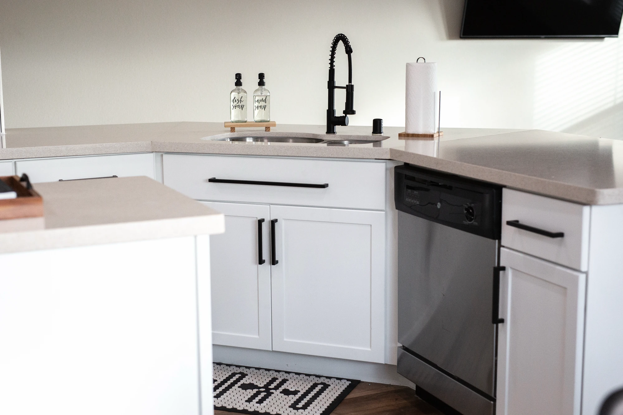 Kitchen sink and dishwasher set in white base cabinets