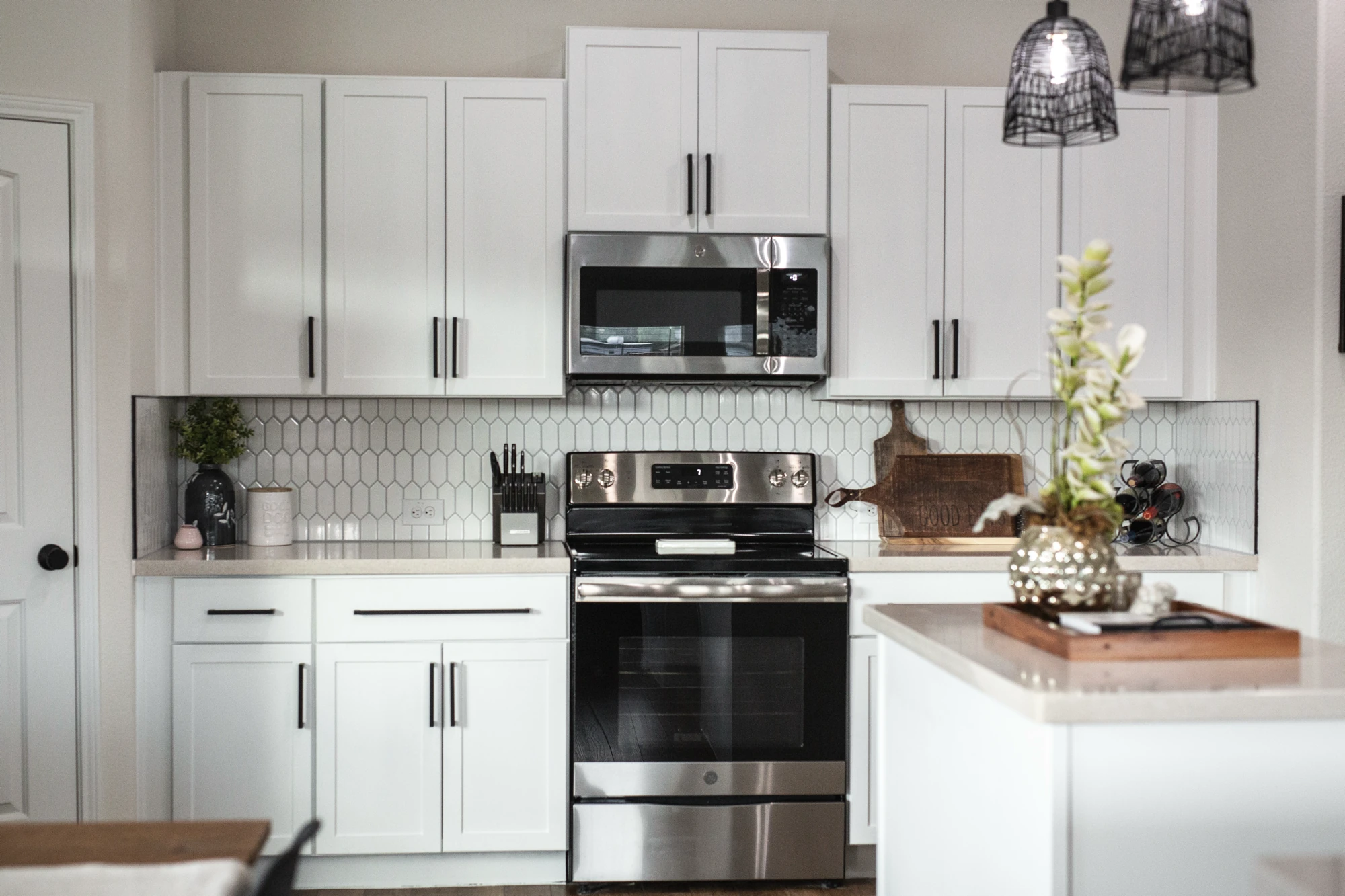 White kitchen range wall with geometric tile backsplash