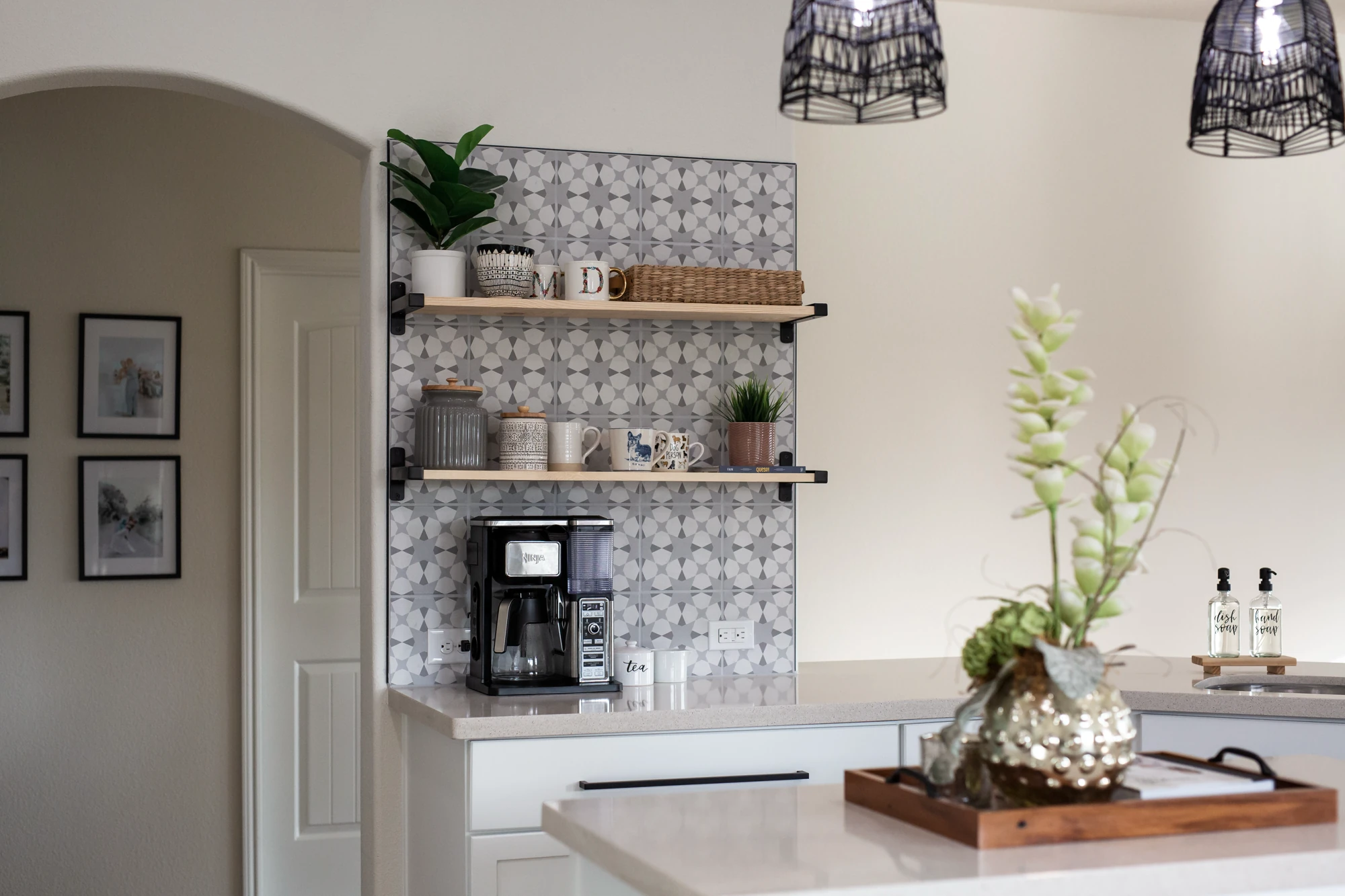 Kitchen coffee station with patterned backsplash and open shelves