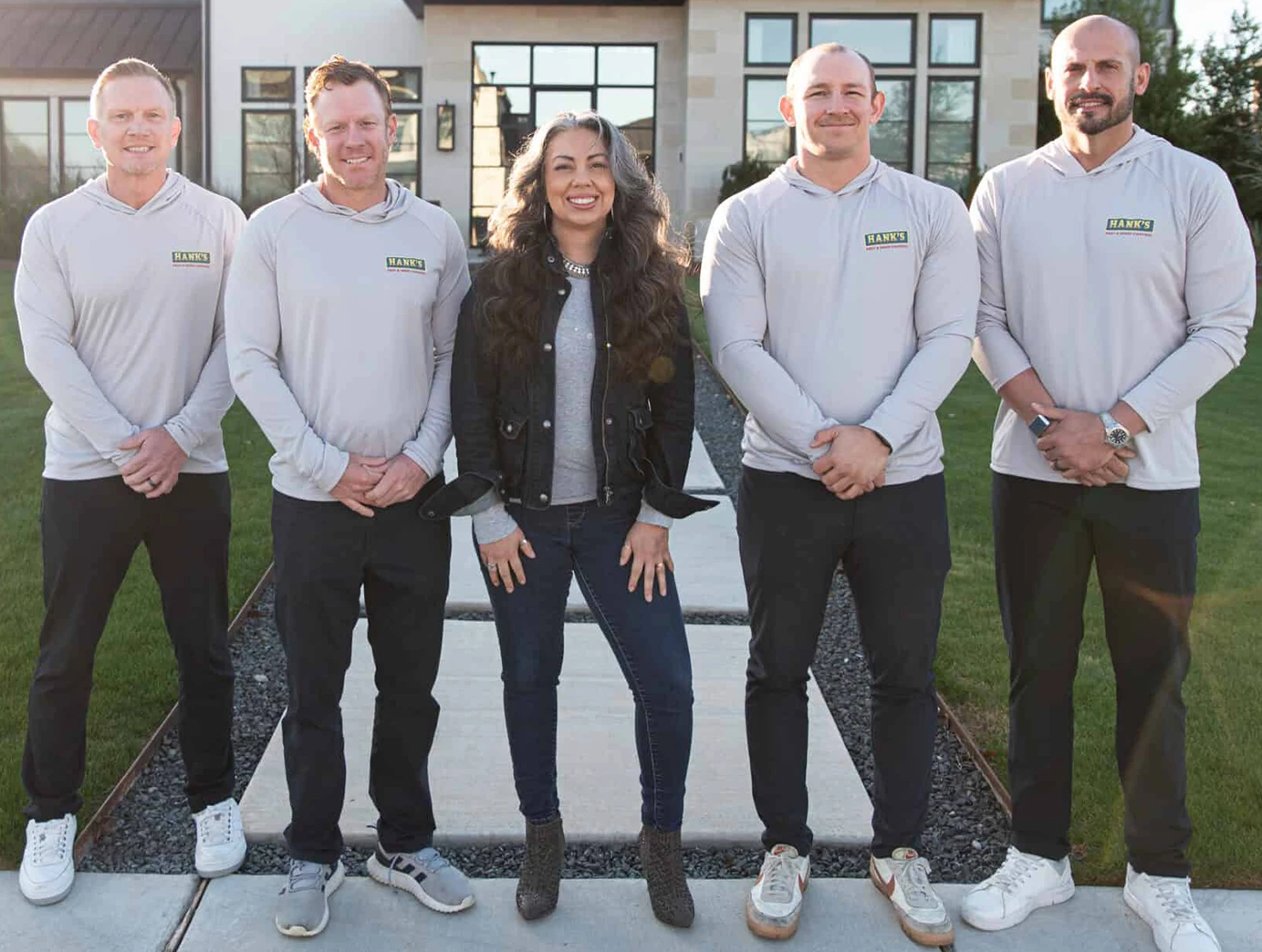 Hank's home service team standing together outside a customer home