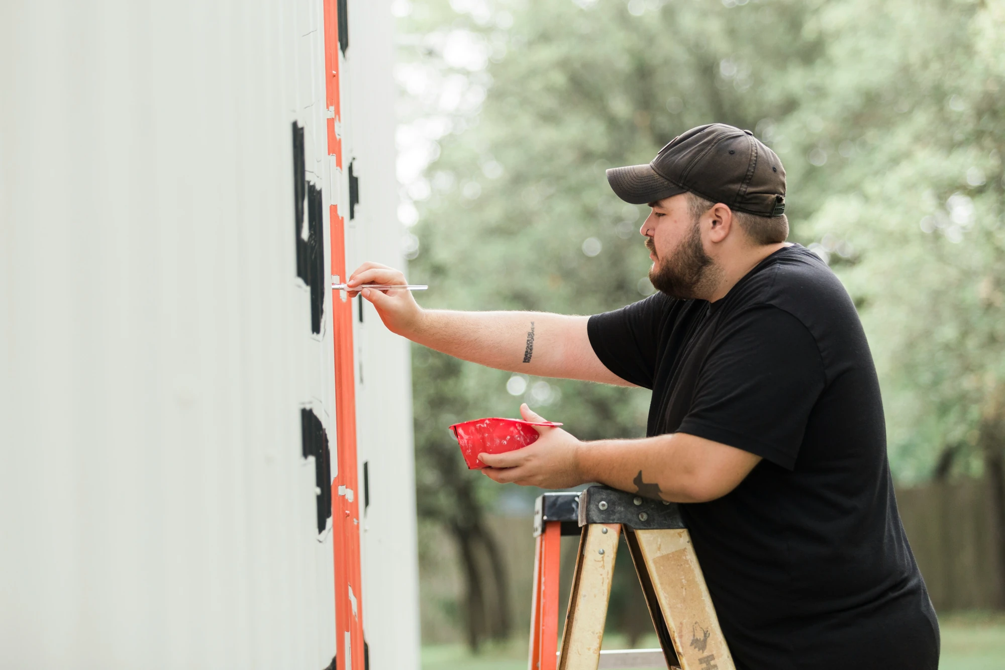 jesus-loves-austin-l0U0nrep1NM-unsplash Painter applying fresh color to an exterior wall