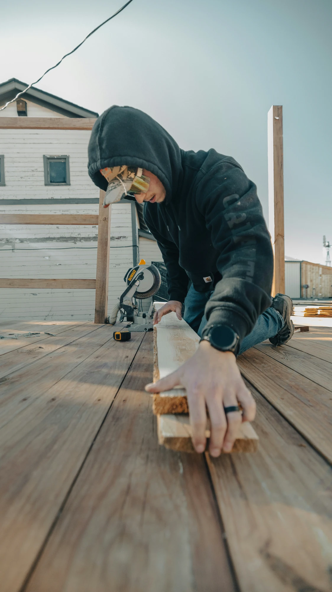 Contractor installing exterior trim or siding beside a home