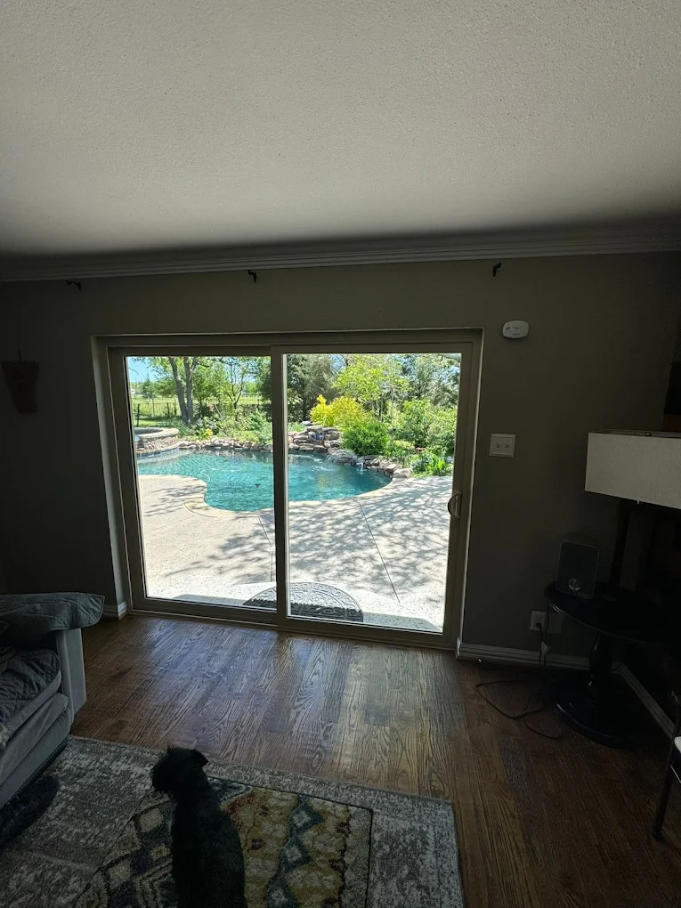 Interior view of a sliding glass door opening to a backyard