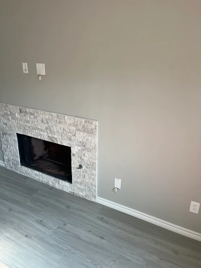 Modern tiled fireplace in a freshly painted living room