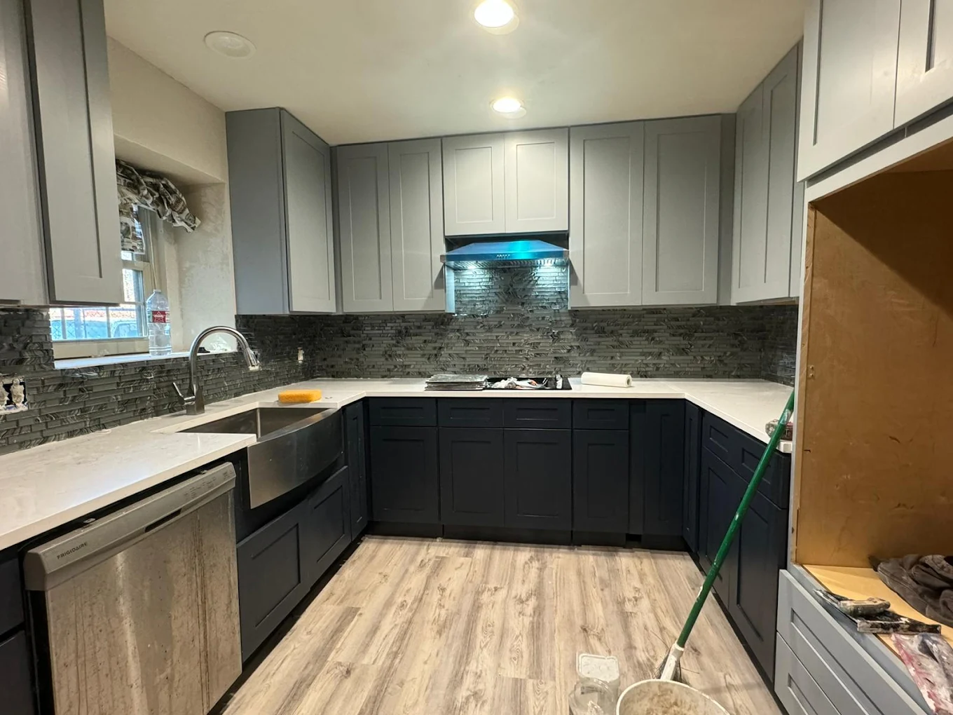 Remodeled kitchen with dark cabinets and light countertops