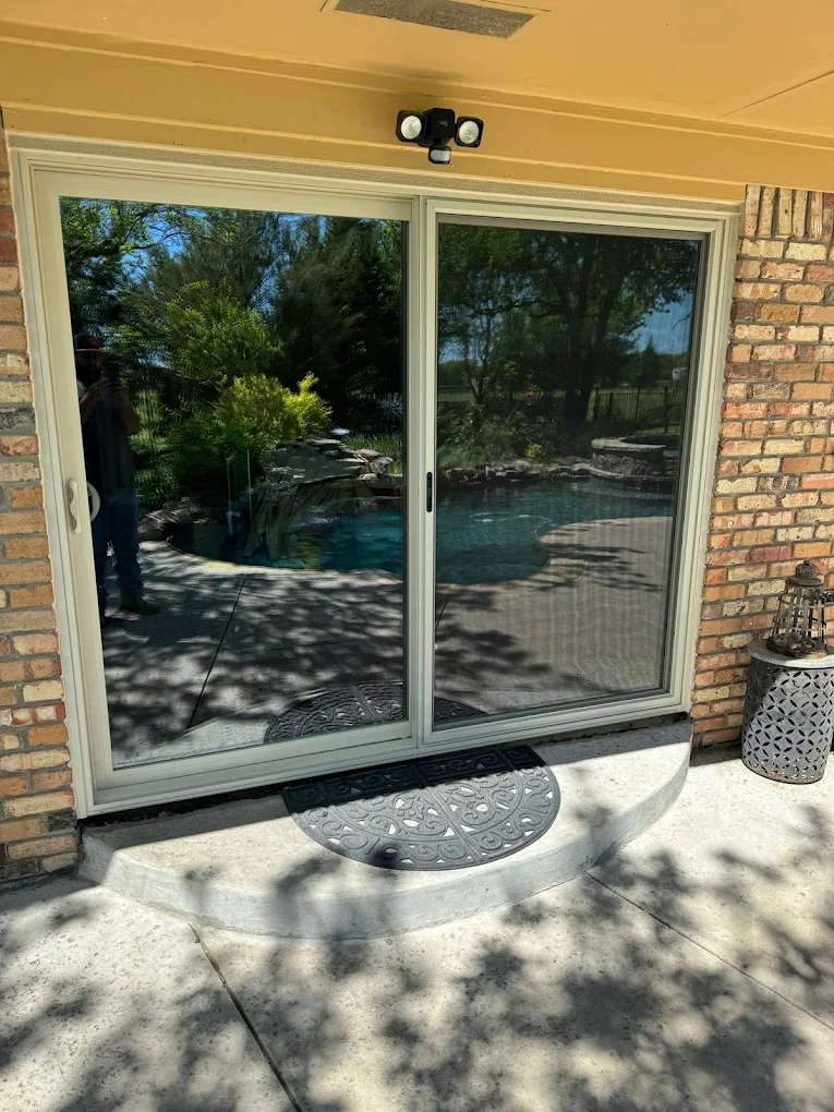 Sliding glass patio door installed in a brick exterior wall
