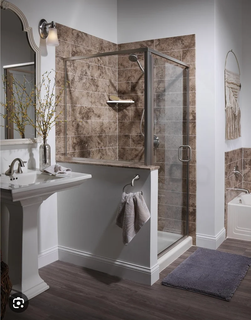 Bathroom with a tiled glass shower and gray wood-look flooring