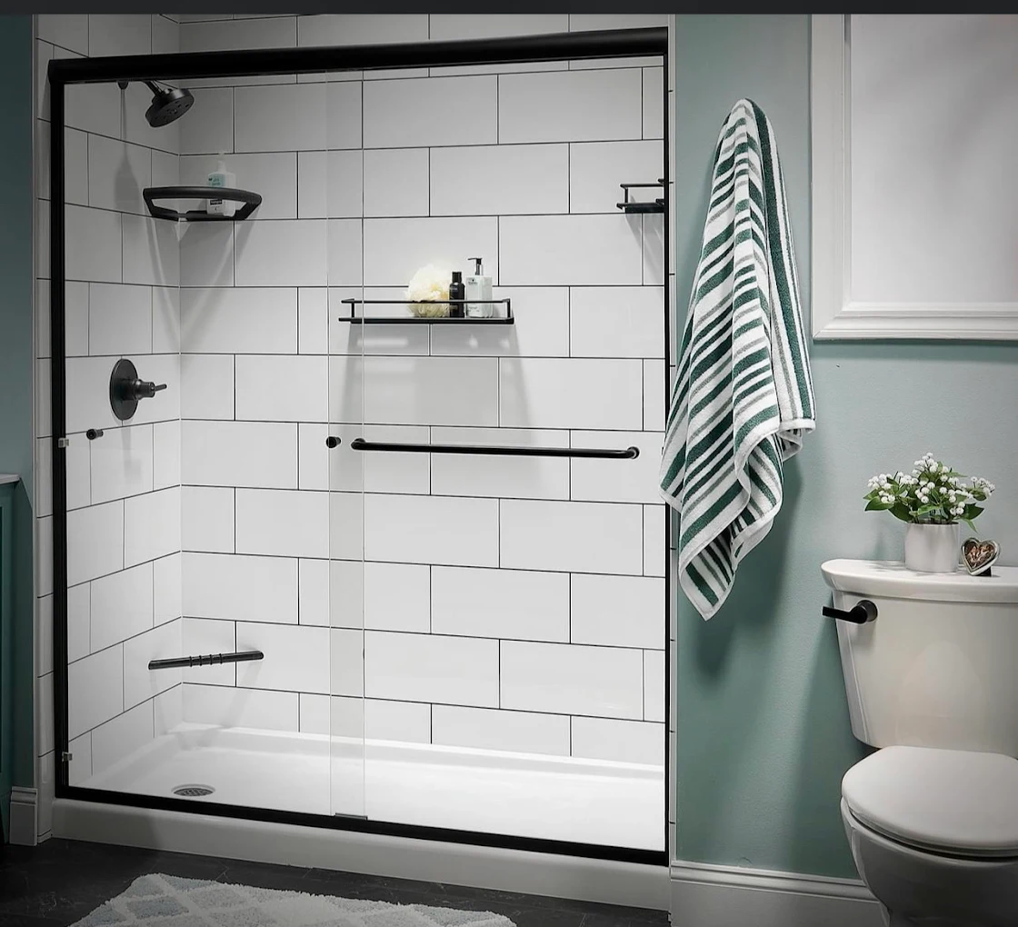 White subway tile shower with black fixtures and glass doors