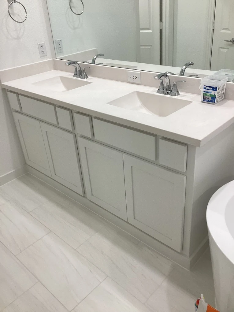 Bathroom vanity with gray cabinets and a white countertop