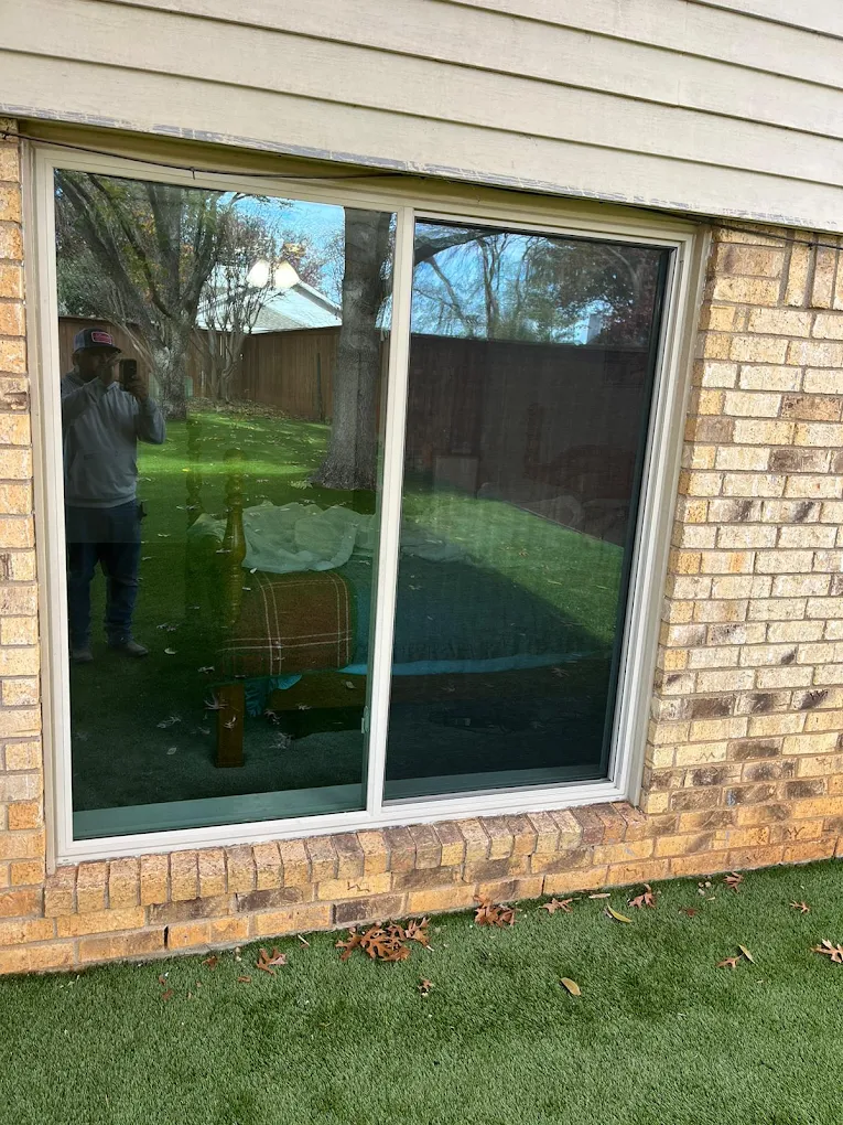 Large replacement window installed in a brick exterior wall