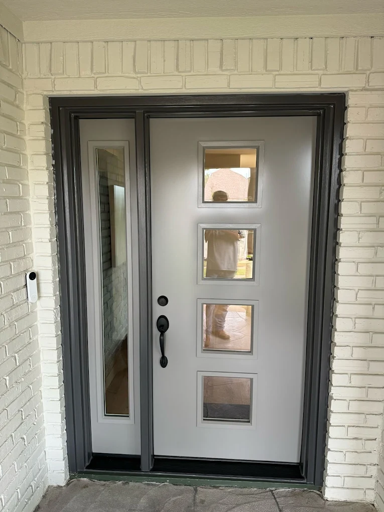 Modern dark front door with four square glass panels