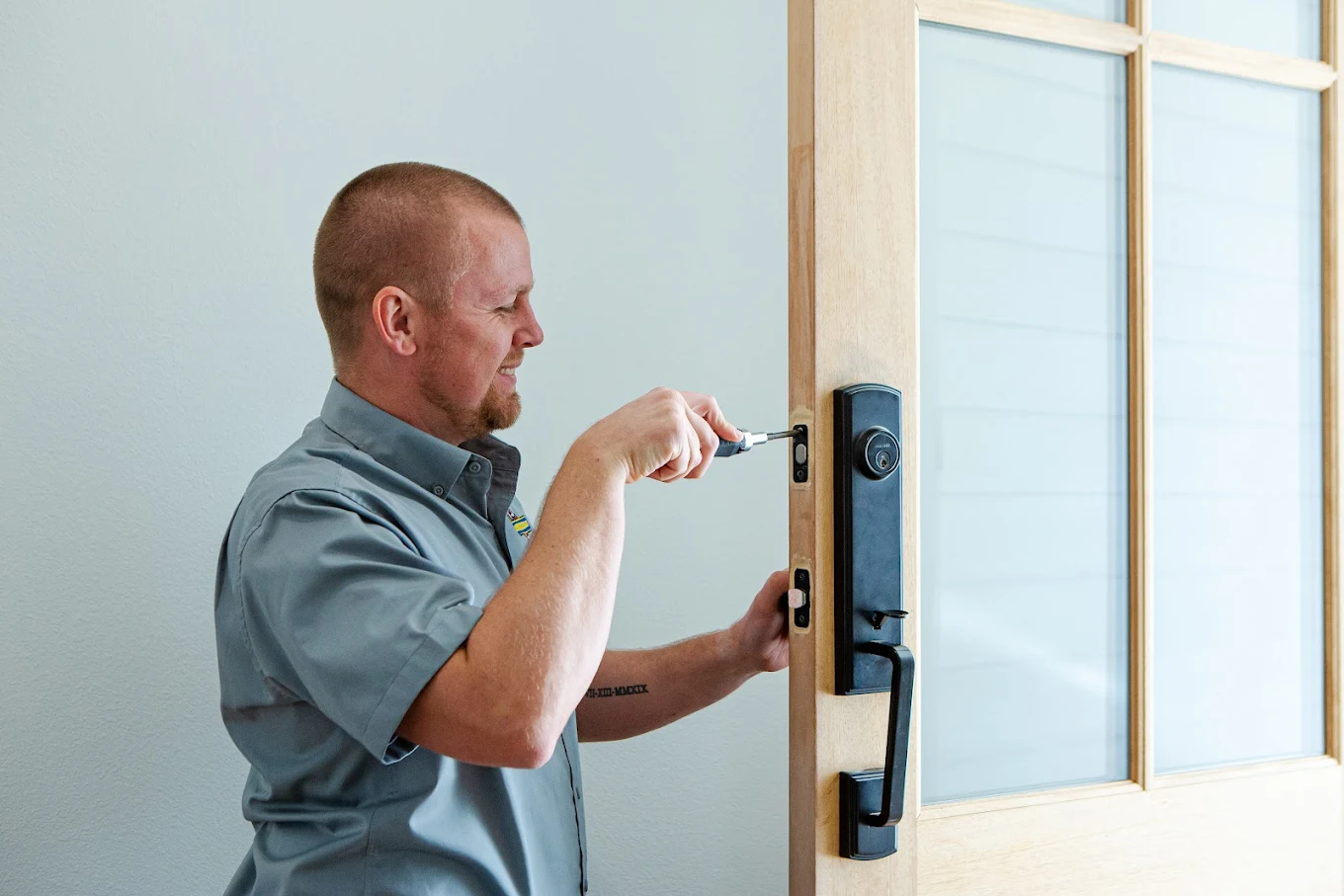 unnamed (62) Hank's technician adjusting the lock on an exterior door